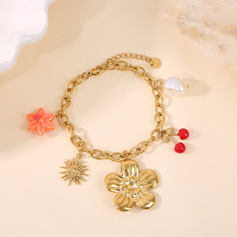 Bracelet doré breloques fleur cerise soleil et perle