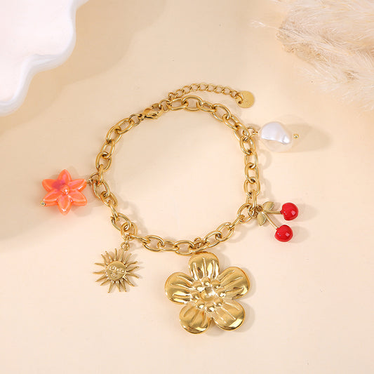 Bracelet doré breloques fleur cerise soleil et perle