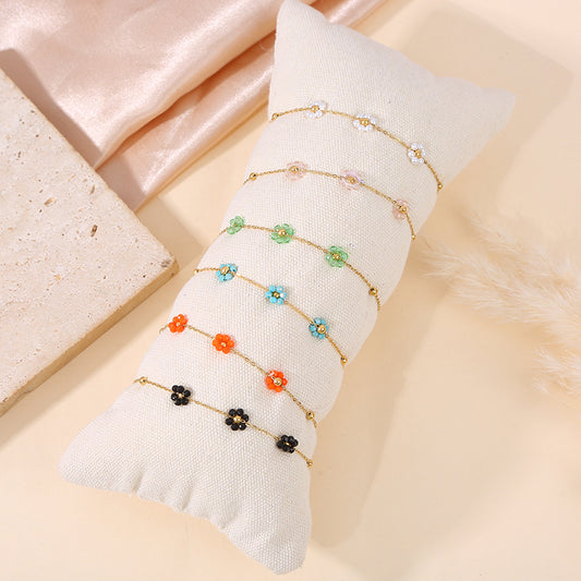 Lot de 6 bracelets fleurs colorées sur coussin