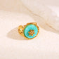 Bague dorée pierre ronde avec fleur interne